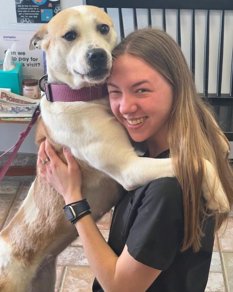 Callie Selin hugging a yellow lab Callie Selin hugging a yellow lab